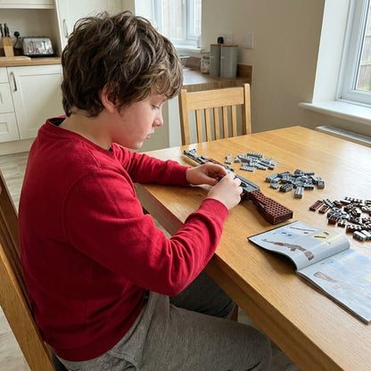 Boy building the AK-47 brick kit himself at the kitchen table