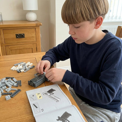Boy building the Magnum Eagle brick pistol himself at his desk