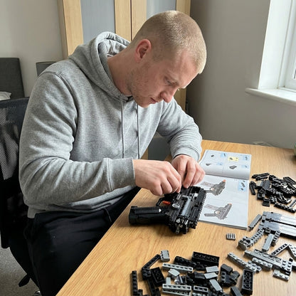 Building the SIG MCX brick kit at a desk: receiver first, loose bricks and the manual