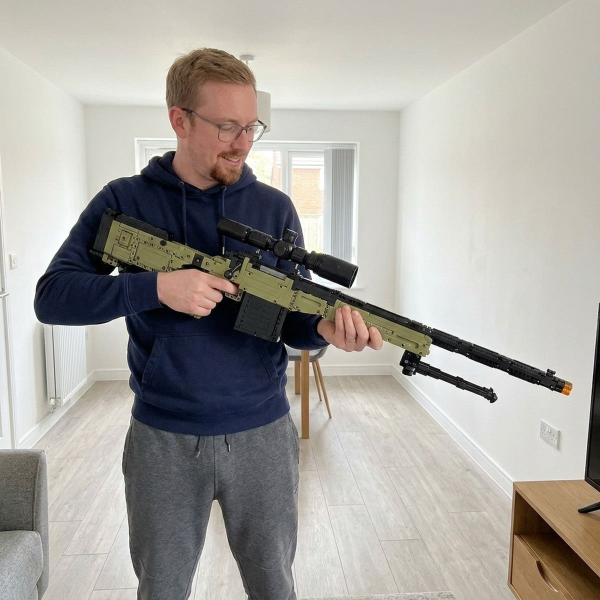 Holding the finished Super Magnum brick model in a bright living room